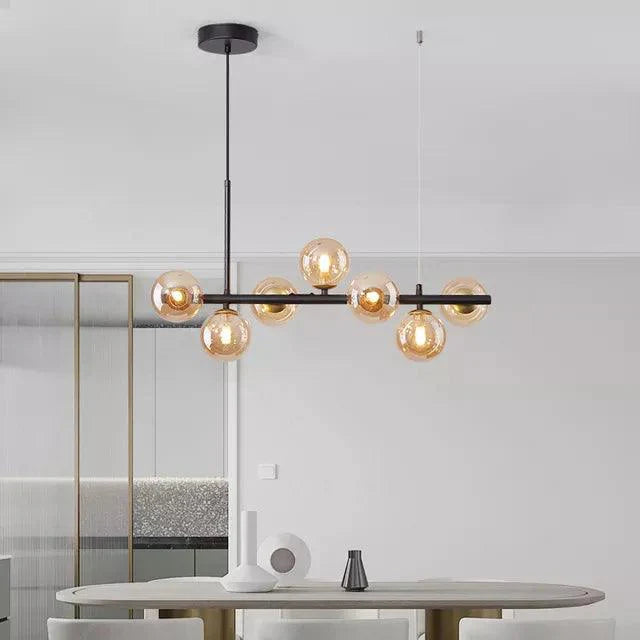 LumaSphere - Moderne lysekrone med lang pendel over bordet